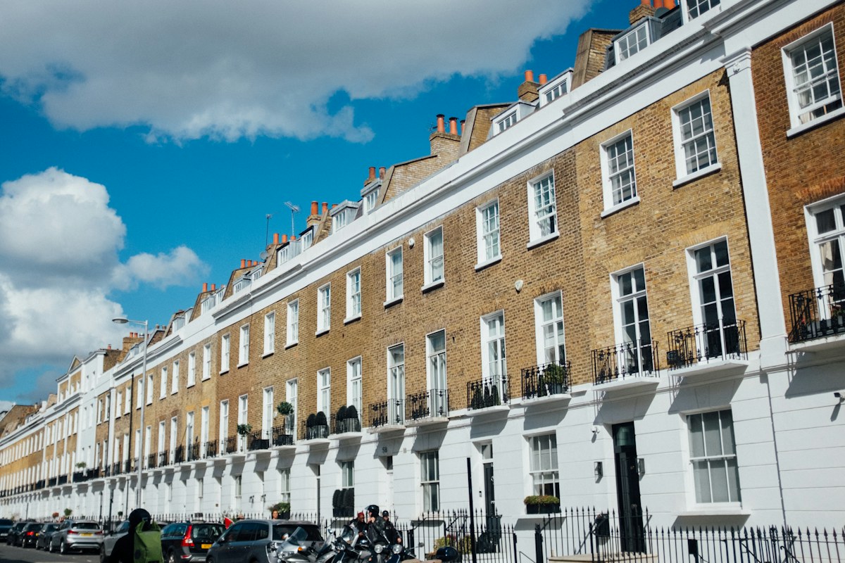 Row of traditional terraced houses under a blue sky